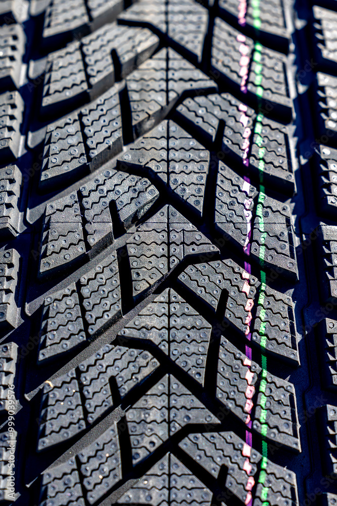 Sharp tread of new winter tires ready for the seasonal change. New tires are important for increasing road safety