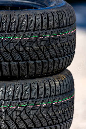 Obraz na płótnie Sharp tread of new winter tires ready for the seasonal change. New tires are important for increasing road safety w salonie