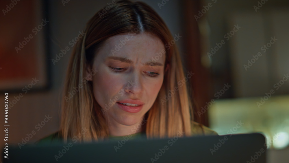 Stressed girl talking online conference by computer in dark home close up. Stressed girl talking online conference by computer in dark home close up.
