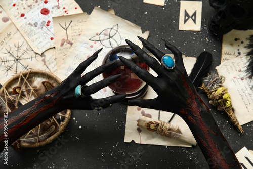 Bloody witch hands with mag...