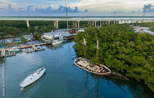 Sunken sailing boat and trees off Highway 1 in Key Largo, Floriday Keys, Florida, United States. photo