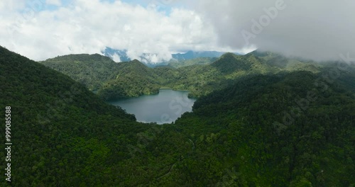 Aerial drone of lake in the mountains among the rainforest and jungle. Balinsasayao Twin Lakes Natural Park. Negros, Philippines photo