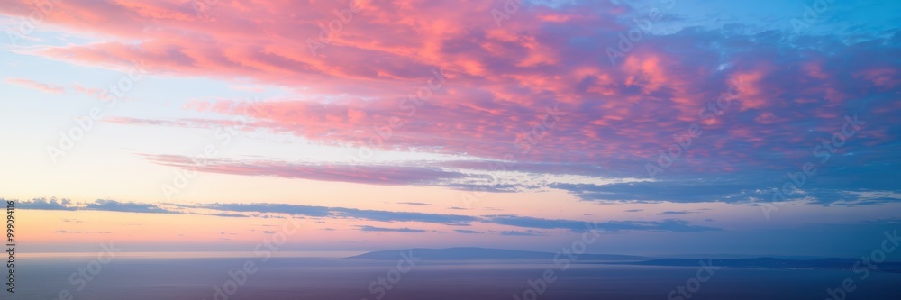 Breathtaking sunset over a tranquil ocean with pink and blue clouds painting the sky. Breathtaking sunset over a tranquil ocean with pink and blue clouds painting the sky.