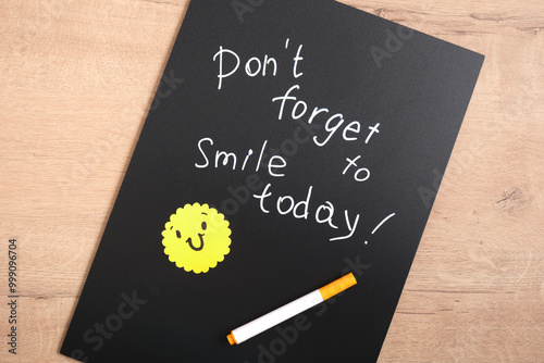 don't forget to smile today text chalk marker on black board yellow smile