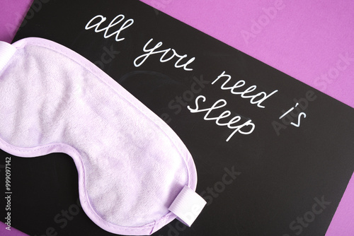 on a black chalk board the inscription all you need is sleep, a sleep mask, insomnia and sleep disorders concept photo