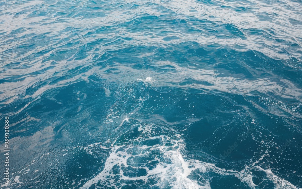 Vast blue ocean waves with white foam forming under the sunlight. Vast blue ocean waves with white foam forming under the sunlight.