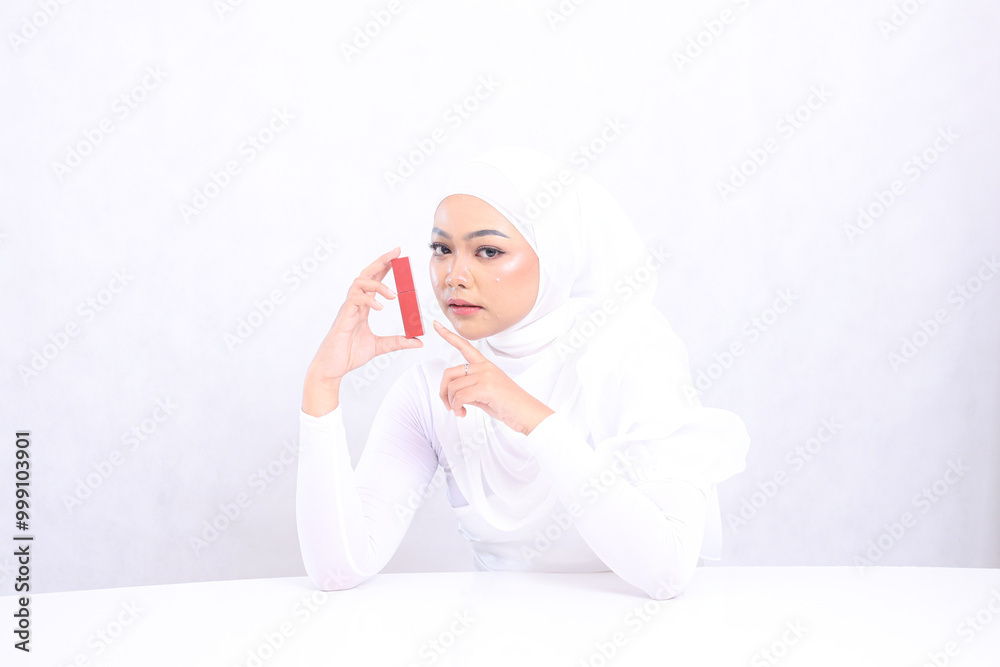Lip makeup view Beautiful young hijab female asia relax look at camera hand holding and touching lipstick container isolated white background. beauty education concept, lip care, lipstick mock up Lip makeup view Beautiful young hijab female asia relax look at camera hand holding and touching lipstick container isolated white background. beauty education concept, lip care, lipstick mock up