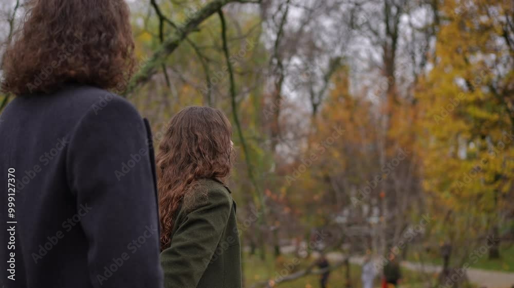 A closeup of two individuals thoroughly enjoying a peaceful and serene autumn day amidst the beauty of nature A closeup of two individuals thoroughly enjoying a peaceful and serene autumn day amidst the beauty of nature