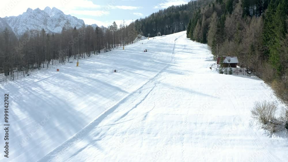 A scenic ski slope stretching into the distance, framed by snow-covered trees and a rustic wooden cabin. The clear blue sky contrasts beautifully with the snow, evoking a sense of winter adventure. A scenic ski slope stretching into the distance, framed by snow-covered trees and a rustic wooden cabin. The clear blue sky contrasts beautifully with the snow, evoking a sense of winter adventure.