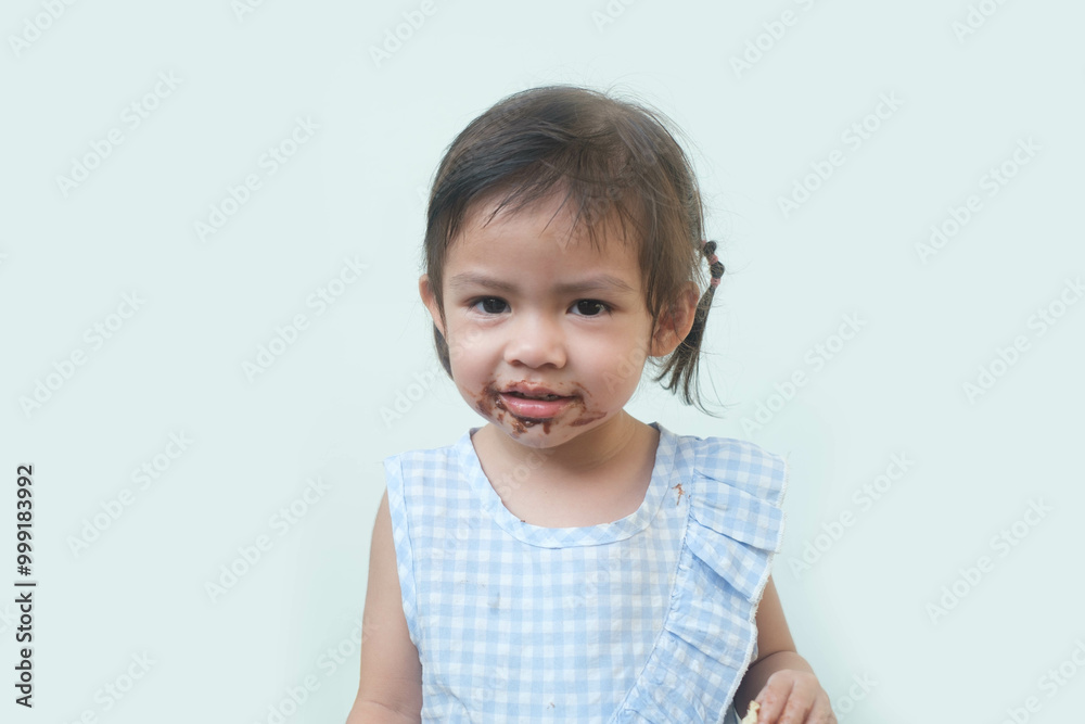 A cheerful young girl with a playful smile, enjoying her treat, showcasing innocence and joy in a bright setting. A cheerful young girl with a playful smile, enjoying her treat, showcasing innocence and joy in a bright setting.