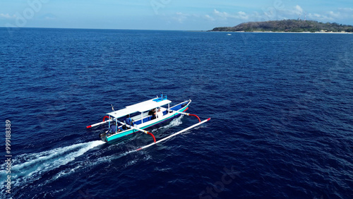 Indonesian fishing trimaran in motion. Tourists travel to the Gili Islands on a trimaran with a local guide. Indonesia Travel