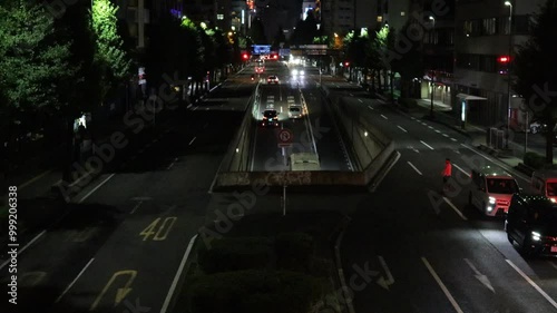 September 23, 2024. Sendai City, Miyagi Prefecture. A group of cars heading towards Sendai City from the West Road at night and a person crossing the street where there is no crosswalk.