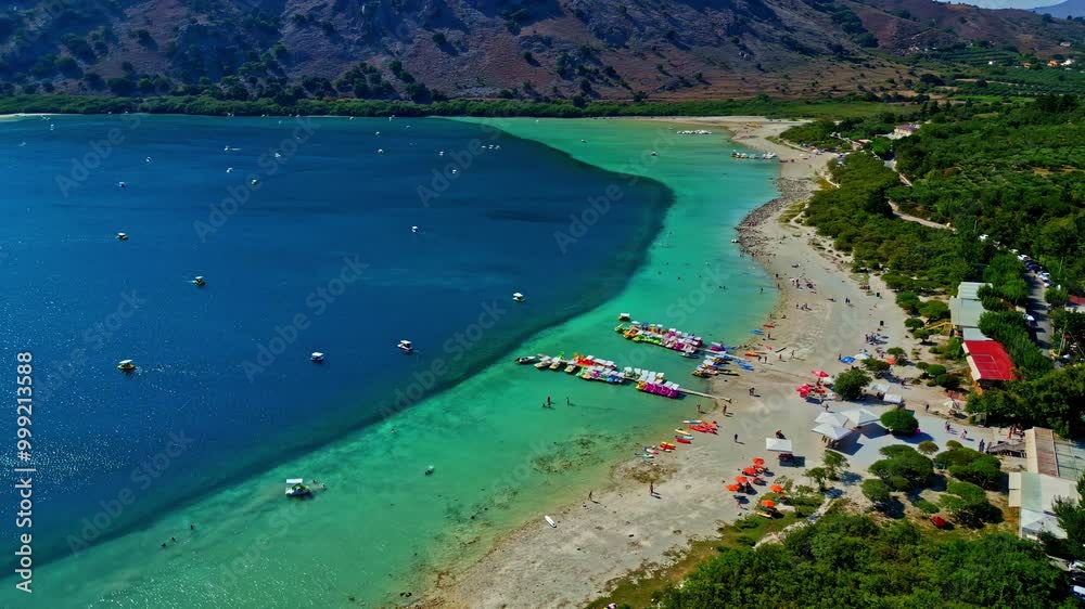 Drone Establishing above Greek clean mediterranean blue sea beach of Lake Kournas on the island of Crete, Greece, village of Kournas Drone Establishing above Greek clean mediterranean blue sea beach of Lake Kournas on the island of Crete, Greece, village of Kournas