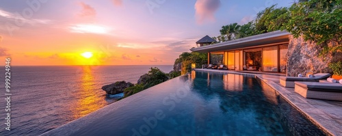 Luxurious cliffside infinity pool overlooking the ocean, tropical getaway during sunset