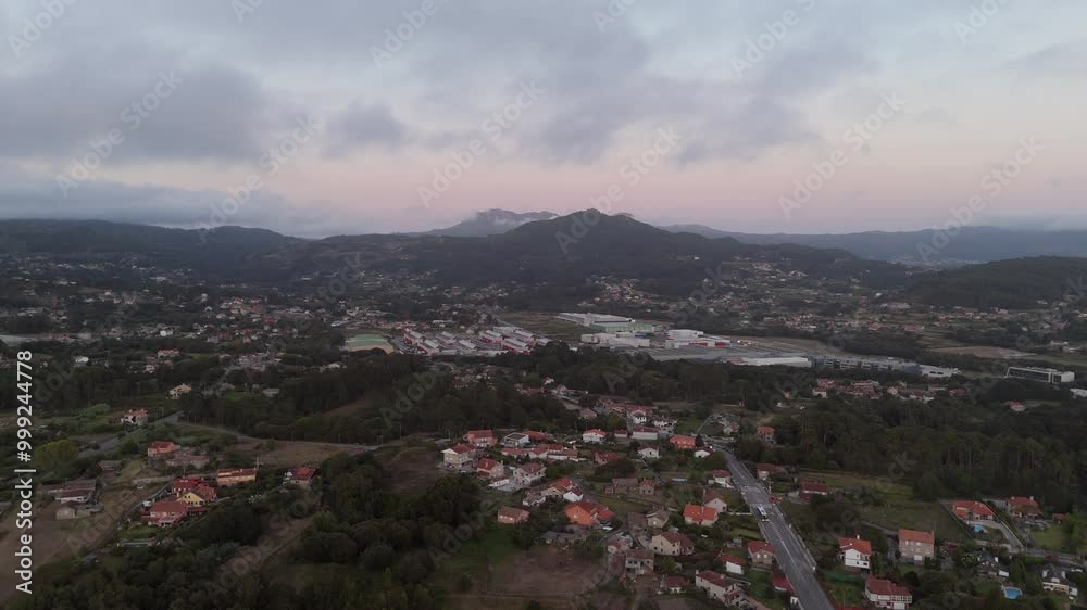 aerial - view over Nigrán’s industrial and commercial zone, surrounded by homes and hills aerial - view over Nigrán’s industrial and commercial zone, surrounded by homes and hills