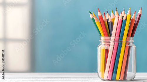 Colorful pencils in transparent jar create vibrant and artistic display