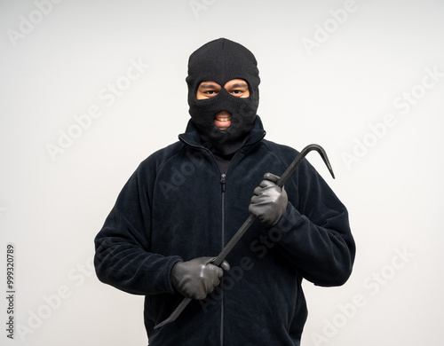 Thief in uniform black jacket various pose on isolated background. The Robber terrorism criminal escapes with balaclava and crowbar entering a house for stealing Housebreak