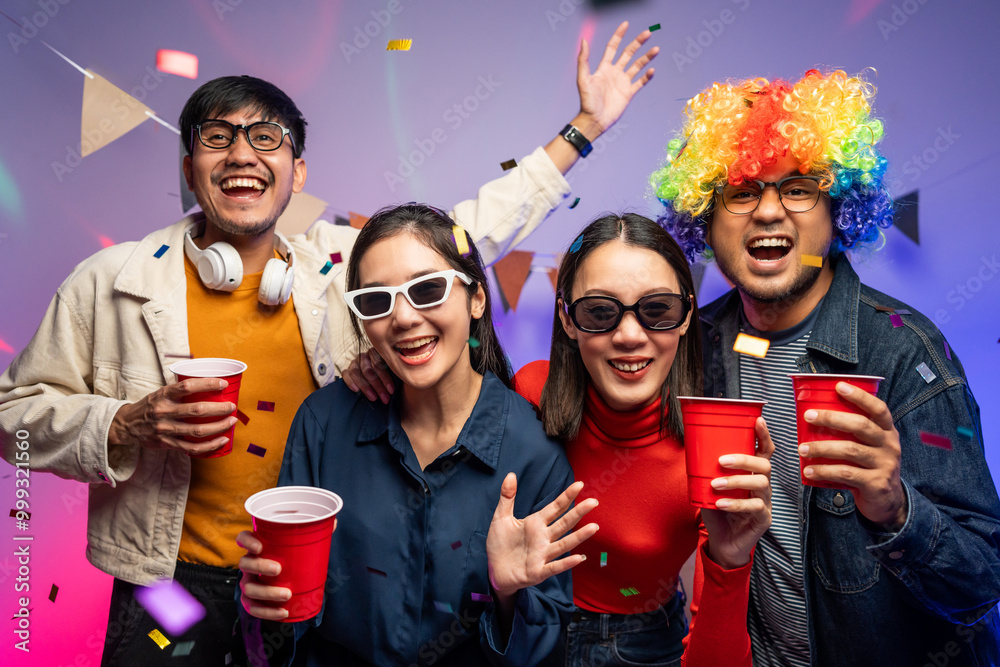 Obraz premium New Year's Party. Group of asian friend party in the house with disco light having fun and dancing together. Enjoy Singing karaoke listening music drinking beer celebration in new year happy hour.