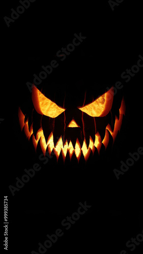 Halloween pumpkin with fangs on black background