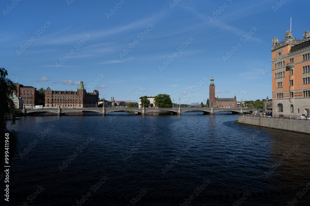 Naklejka premium Stockholm, Sweden - 22nd of July 2023. Stockholm harbour with the town hall in the background.