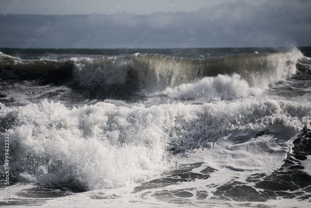 Large ocean waves crashing on beach 