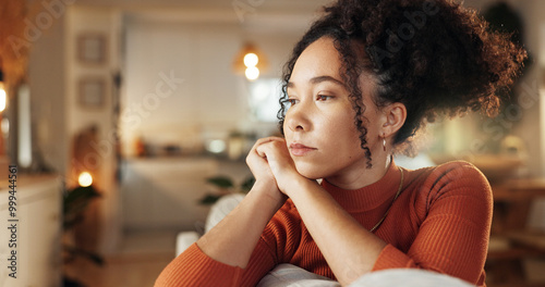 Depression, heartbreak and sad with face of woman on sofa in living room of home for contemplation. Bored, lonely and thinking with unhappy African person in apartment for breakup or separation