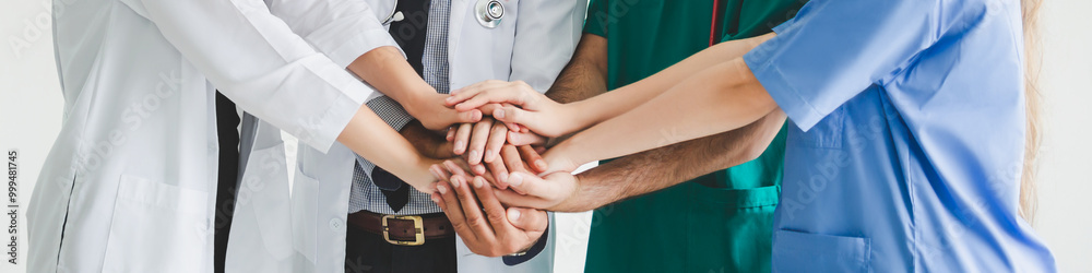 Obraz premium Teamwork group doctor surgeon nurse putting their hand together on white background medical health care solidarity concept