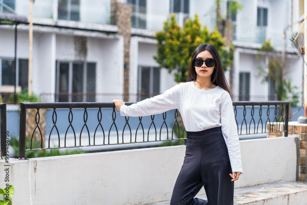 Outdoor Mockup: Young Woman in White Long Sleeve Shirt Posing at a Park Outdoor Mockup: Young Woman in White Long Sleeve Shirt Posing at a Park