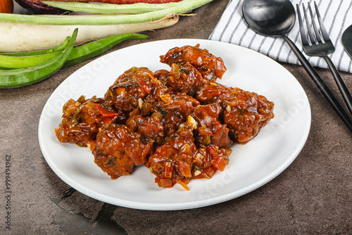 Manchurian chicken with sauce and spices photo