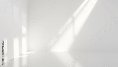 White room interior with sunbeams and shadows on the wall and floor.