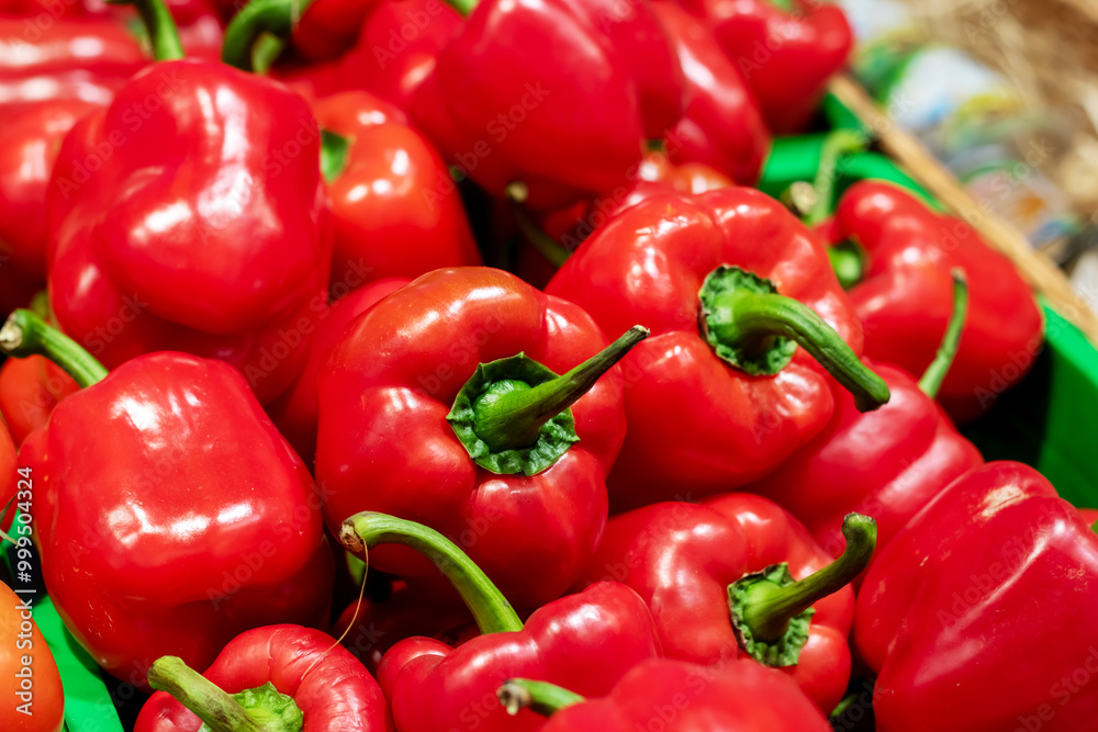 A green basket that is filled with vibrant red peppers is sitting on a table A green basket that is filled with vibrant red peppers is sitting on a table