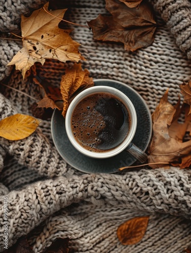 A cup of black coffee on a knitted blanket. Autumn aesthetic photo