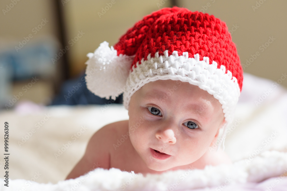 Beautiful baby in a Christmas hat isolated on white background Beautiful baby in a Christmas hat isolated on white background