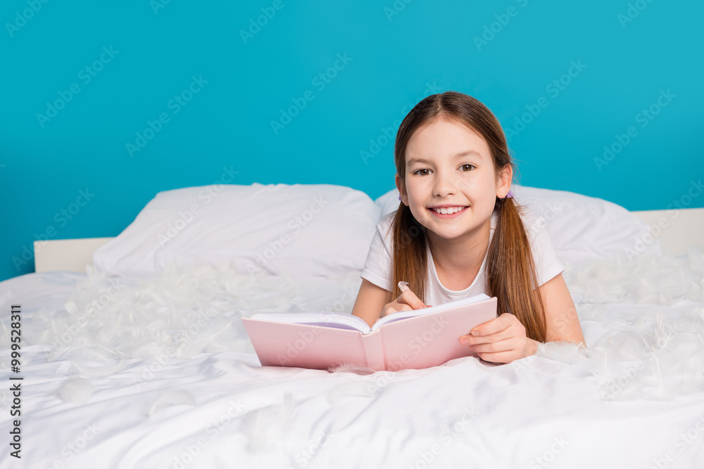 Photo of pretty lovely charming girl lying comfortable bed in sleepwear isolated on blue color background Photo of pretty lovely charming girl lying comfortable bed in sleepwear isolated on blue color background