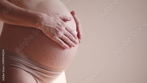 Wallpaper Mural pregnant woman. health pregnancy motherhood procreation concept. close-up belly of sunlight a pregnant woman. woman waiting for a newborn baby. pregnant woman holding her belly indoors Torontodigital.ca