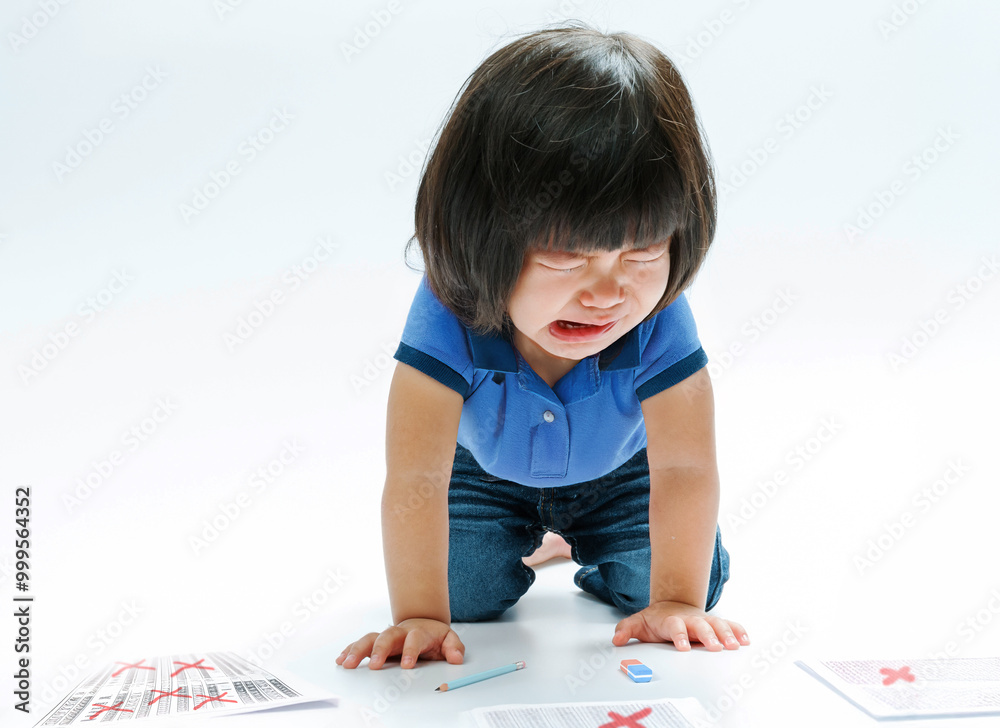 Asian girl crying in exam regret on background In the content knowledge of managing children's emotional sorrow in disappointment. Asian girl crying in exam regret on background In the content knowledge of managing children's emotional sorrow in disappointment.