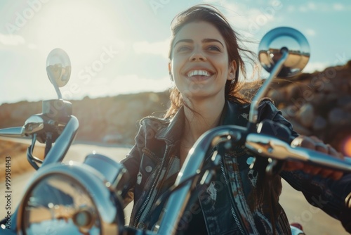 A woman rides her motorcycle down a winding road