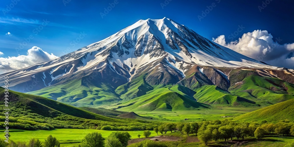 Mount Damavand rises elegantly, its snowy apex contrasting with lush greenery, complemented by a brilliant blue sky,