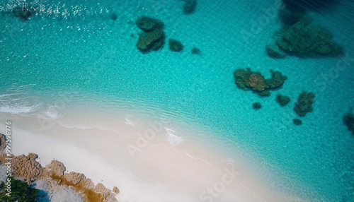 An aerial view of a pristine beach with turquoise waters gently lapping against the white sand