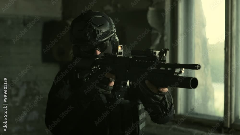 Special forces operator in all black military gear checking his collimator sight on an m4 assault rifle Special forces operator in all black military gear checking his collimator sight on an m4 assault rifle