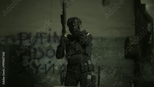 Wallpaper Mural Special forces operator in black military gear inserting a magazine in his m4 assault rifle Torontodigital.ca