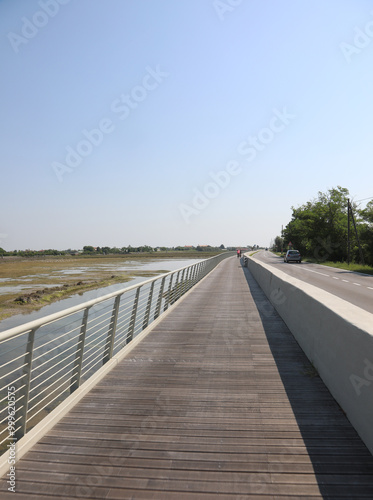 cycle path made of wood and steel railings that runs along the Venetian lagoon at Treporti near Jesolo and the island of Venice