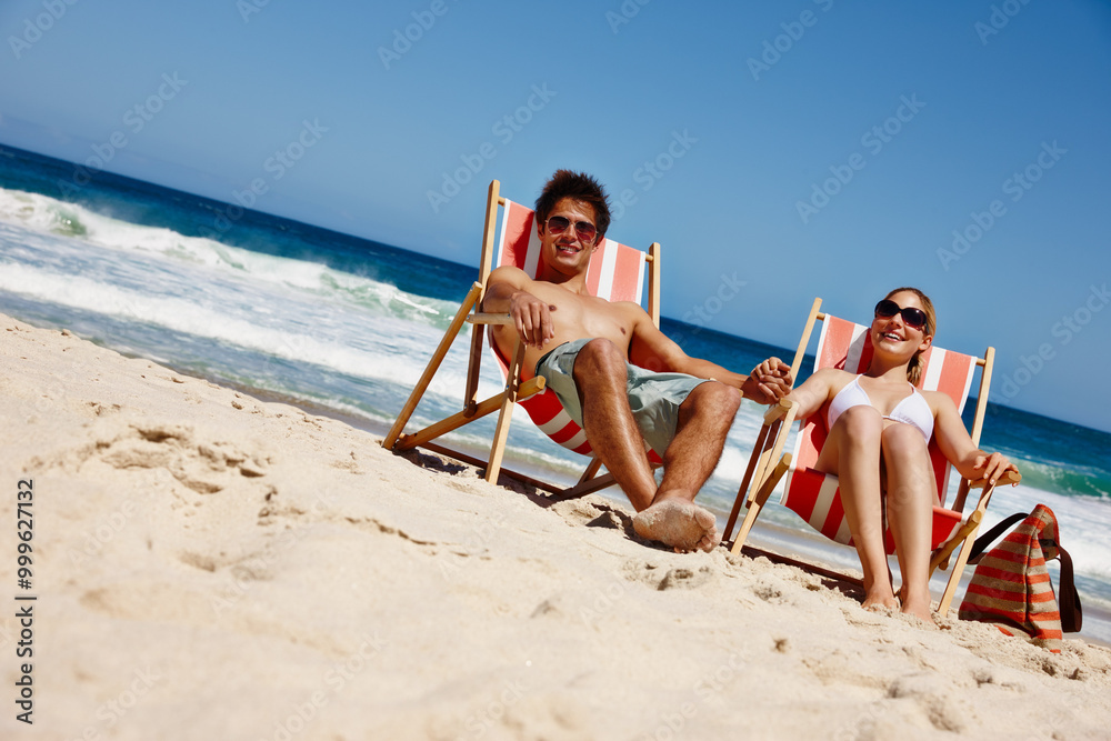Fototapeta premium Couple, sunglasses and relax at beach for travel, bonding and tropical holiday with chair on sand. Man, woman and ocean outdoor for trip, love and vacation with sunshine, smile and weekend in Greece