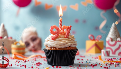 Birthday cupcake with burning lit candle with number 97. Number ninety-seven for ninety-seven years or ninety-seventh anniversary. photo