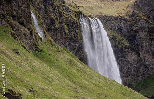 closeup photo of the top of Seljalandsfoss waterfall cascading from cliff edge Iceland