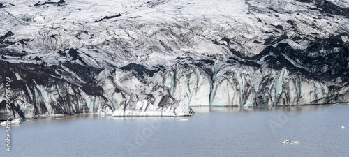 ash-covered icebergs glacier with crevasses, at the terminus of Sólheimajökull glacier, South Iceland