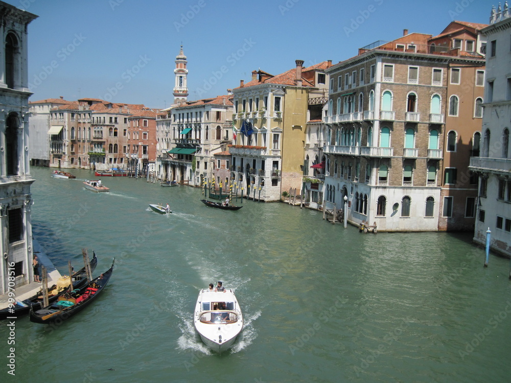 grand canal city. Romantic Venetian landscape. Tourists in a gondola on a walk along a Grand Canal in the old town. Famous historical heritage city. grand canal city. Romantic Venetian landscape. Tourists in a gondola on a walk along a Grand Canal in the old town. Famous historical heritage city.