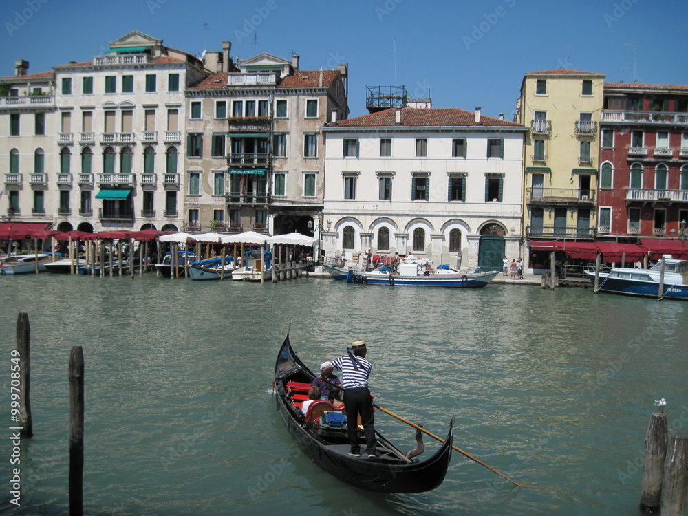 gondolas. Romantic Venetian landscape. Tourists in a gondola on a walk along a Grand Canal in the old town. Famous historical heritage city. gondolas. Romantic Venetian landscape. Tourists in a gondola on a walk along a Grand Canal in the old town. Famous historical heritage city.
