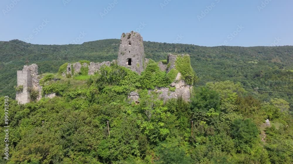 Ancient castle ruins in Georgia: stone walls and green hills Ancient castle ruins in Georgia: stone walls and green hills