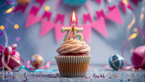 Birthday cupcake with burning lit candle with number 75. Number seventy-five for seventy-five years or seventy-fifth anniversary. photo